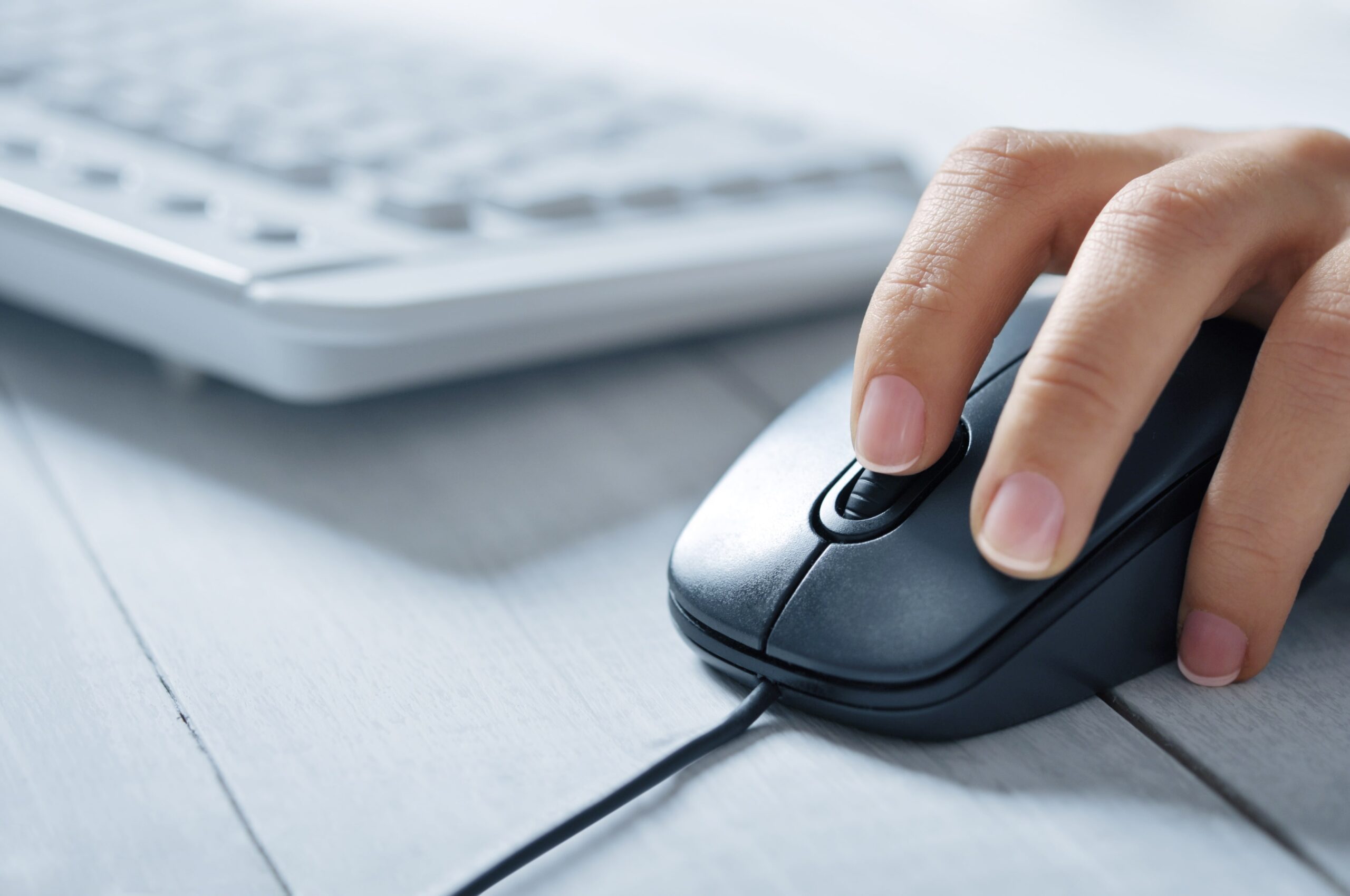 Close-up of hand clicking computer mouse