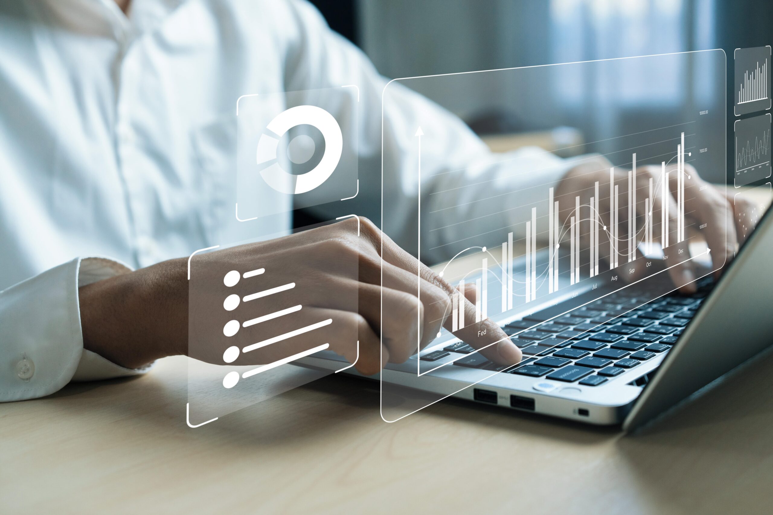Close-up of man typing on laptop, overlaid with digital progress charts